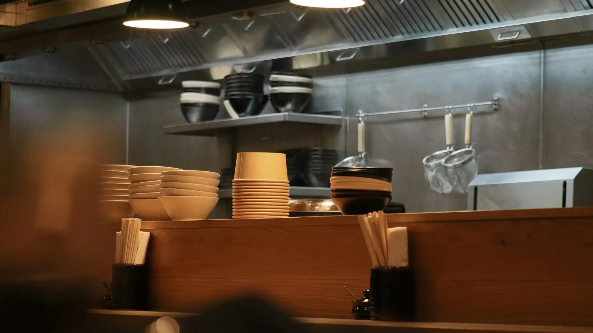 Stainless steel prep area inside a compact commercial food kitchen