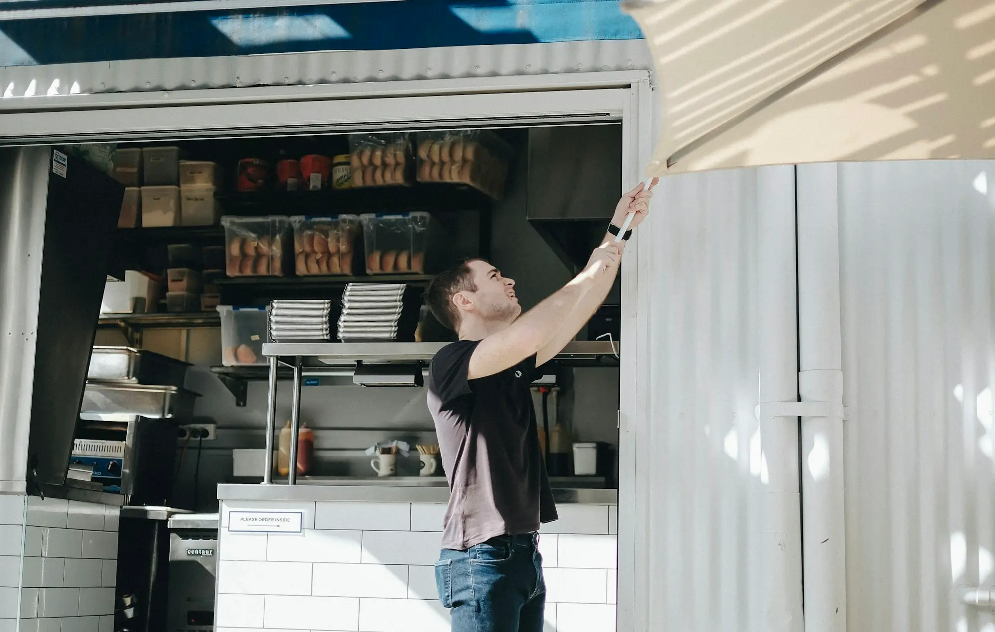 Owner working inside a small café kiosk in Brisbane City
